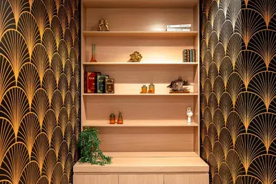 a book shelf with a plant in a room at KeyRock Living - Golf Gate Apt with Pool Access in Dubai