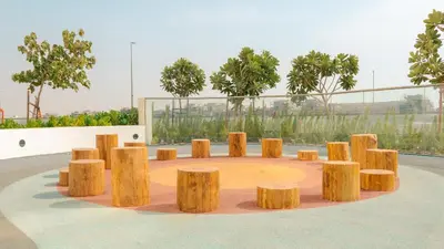 a group of wooden stools in a circle at KeyRock Living - Golf Gate Apt with Pool Access in Dubai