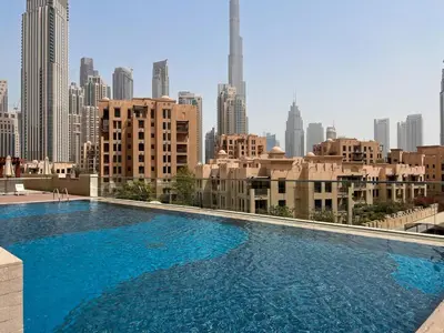 a large swimming pool with a view of the city at Vogue Downtown Bellevue Towers near Burj Khalifa and Dubai Mall, One Bedroom Apartment with City View, Full Access to all Amenities in Dubai