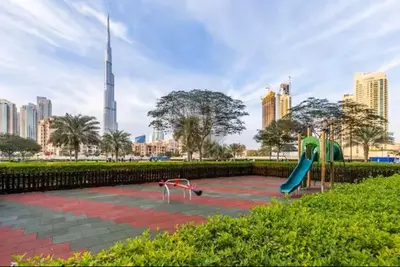 a park with a playground with a slide at Vogue Downtown Bellevue Towers near Burj Khalifa and Dubai Mall, One Bedroom Apartment with City View, Full Access to all Amenities in Dubai