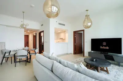 a living room with a couch and a table at Prime Located 2BR Near Burj Khalifa & Dubai Mall in Dubai