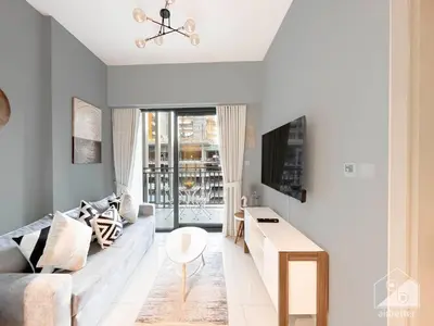a living room with a couch and a table at Wonderful Stay at Zada Tower l 1BR with Balcony in Dubai