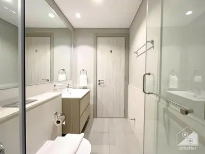 a bathroom with a shower and a toilet and a sink at Wonderful Stay at Zada Tower l 1BR with Balcony in Dubai