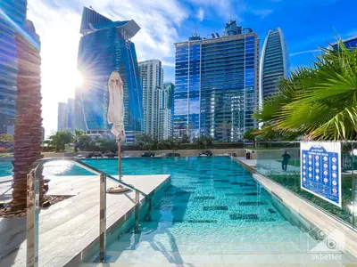 a swimming pool in a city with tall buildings at Wonderful Stay at Zada Tower l 1BR with Balcony in Dubai