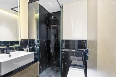 a bathroom with a glass shower and a sink at Comfortable 2 Bedroom in Business Bay in Dubai