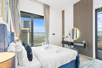 a hotel room with a bed and a large window at Comfortable 2 Bedroom in Business Bay in Dubai