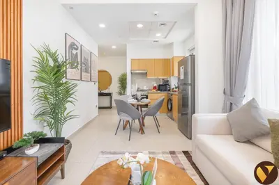 a living room with a couch and a table at Vogue Downtown Bellevue Towers near Burj Khalifa and Dubai Mall, One Bedroom Apartment with City View, Full Access to all Amenities in Dubai