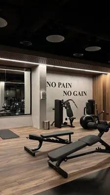 a gym with a no pain no gain sign on the wall at Best Sunrise Holiday Home in Dubai