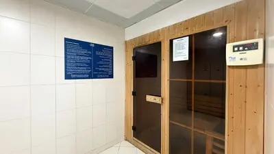 a locker room with a wooden door and signs on the wall at Lux 3BHK in Marina with Pool Table Opal 305 in Dubai