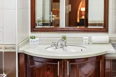 a bathroom with a sink and a mirror at Lux 3BHK in Marina with Pool Table Opal 305 in Dubai