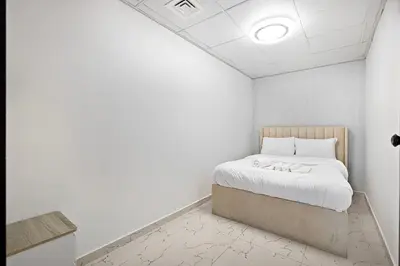 a bedroom with a bed in a white room at Lux 3BHK in Marina with Pool Table Opal 305 in Dubai