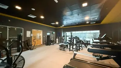 a gym with several treadmills and a bike in a room at Lux 3BHK in Marina with Pool Table Opal 305 in Dubai