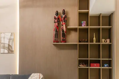 a shelf with two figurines on a wall at Luxury 1 BHK in Dubai Marina JVC 904 in Dubai