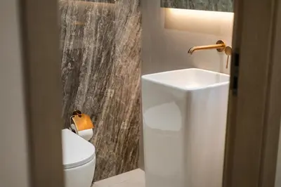a bathroom with a white toilet and a sink at Luxury 1 BHK in Dubai Marina JVC 904 in Dubai