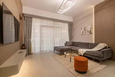 a living room with a couch and a table at Luxury 1 BHK in Dubai Marina JVC 904 in Dubai