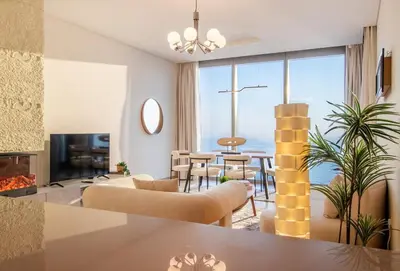 a living room with a view of the ocean at Luxury 2 BHK in Jumeirah By dPie Emaar 2008 in Dubai