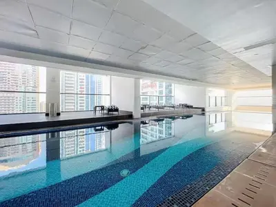 a large swimming pool in a large building at Luxury 2BHK Stunning Skyline Lakeview in JLT 401 in Dubai