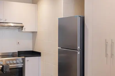 a kitchen with a stainless steel refrigerator at Luxury 2BHK Stunning Skyline Lakeview in JLT 401 in Dubai