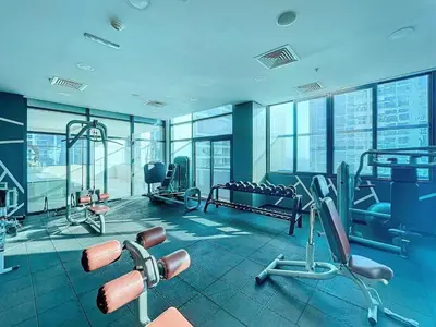 a gym with cardio equipment in a building at Luxury 2BHK Stunning Skyline Lakeview in JLT 401 in Dubai