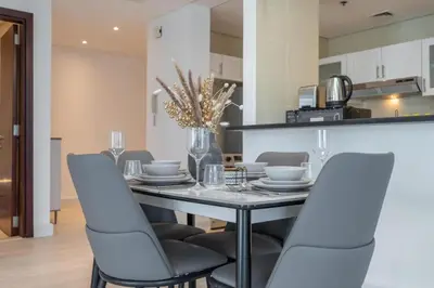 a dining room with a table and chairs at Luxury 2BHK in Jumeirah Late Towers JLT 2609 in Dubai