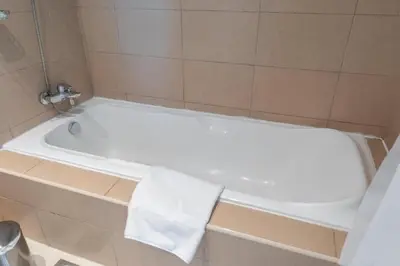a white bath tub with a towel on it in a bathroom at Luxury 2BHK in Jumeirah Late Towers JLT 2609 in Dubai