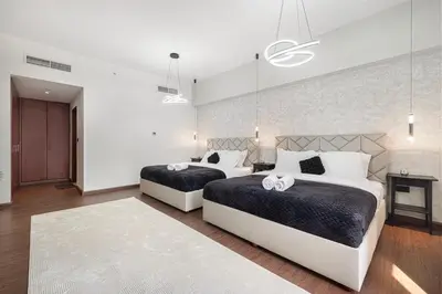 a bedroom with two beds and a fireplace at Lux 4BHK in JBR 5 Mins Walk to Beach Sadaf 8 102 in Dubai