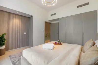 a bedroom with a large white bed in a room at Luxury Villa in Jebel Ali Village By dPie in Dubai