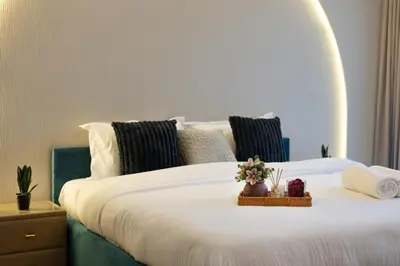 a bedroom with a large white bed with flowers on it at Luxury Villa in Jebel Ali Village By dPie in Dubai