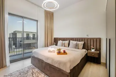 a bedroom with a large bed and a large window at Luxury Villa in Jebel Ali Village By dPie in Dubai