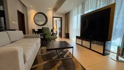 a living room with a couch and a flat screen tv at Luxury 1BHK located in The Matrix 1-2707 in Dubai