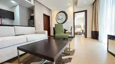 a living room with a couch and a table at Luxury 1BHK located in The Matrix 1-2707 in Dubai