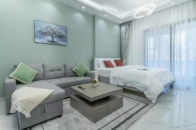 a living room with a bed and a couch and a bed and a bedzinski at Dubai Marina - Perfect Studio Apartment in Dubai