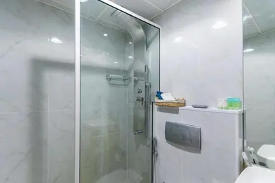 a shower with a glass door in a bathroom at Dubai Marina - Perfect Studio Apartment in Dubai