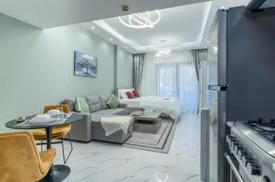 a living room with a couch and a table at Dubai Marina - Perfect Studio Apartment in Dubai