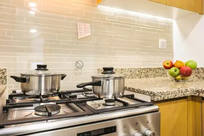 two pots on top of a stove in a kitchen at FIRST CLASS 2BR Downtown Glam Burj View in Dubai