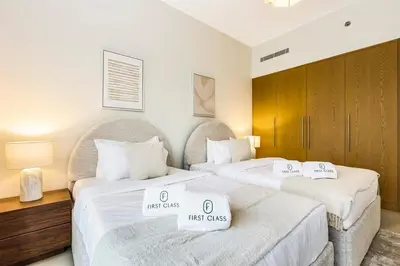 two beds in a hotel room with first class at FIRST CLASS 2BR Downtown Glam Burj View in Dubai