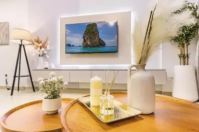 a living room with a table with a vase on it at FIRST CLASS 2BR Downtown Glam Burj View in Dubai