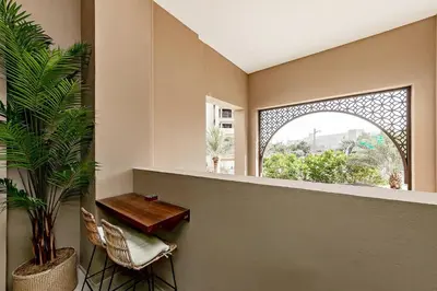 a room with a table and chairs and a window at Modern 1BR Apartment Lamtara 3 in MJL in Dubai