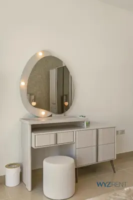 a dressing table with a mirror and a stool at Plush Winter Stay 1BR Park Tower DIFC & Museum in Dubai