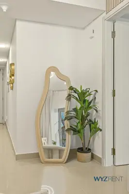 a bathroom with a mirror and a potted plant at Plush Winter Stay 1BR Park Tower DIFC & Museum in Dubai