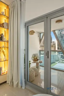 a sliding glass door in a room with a window at Plush Winter Stay 1BR Park Tower DIFC & Museum in Dubai