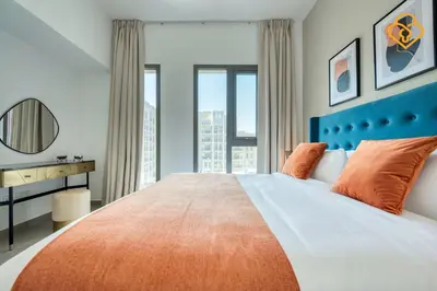 a bedroom with a large bed with orange pillows at Keysplease Great Family 2 BR Apt, Townsquare in Dubai