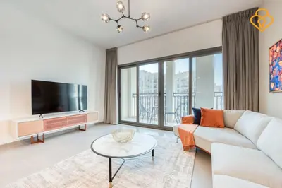 a living room with a couch and a tv at Keysplease Great Family 2 BR Apt, Townsquare in Dubai