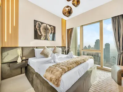 a bedroom with a large bed with a large window at 51st Floor Sea and Skyline Views LUXE 1BR in Dubai