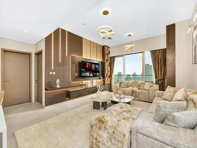 a living room with a couch and a tv at 51st Floor Sea and Skyline Views LUXE 1BR in Dubai