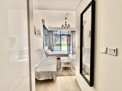 a room with a mirror and a bed and a table at Luxury studio appartment in Sabkhah