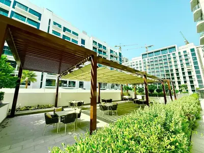 a patio with tables and chairs under a canopy at Luxury studio appartment in Sabkhah