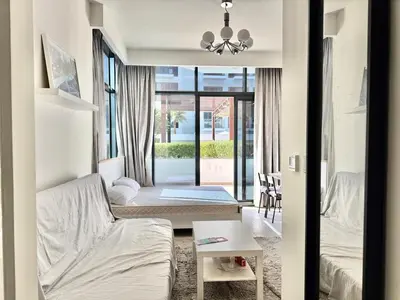 a living room with a bed and a table at Luxury studio appartment in Sabkhah
