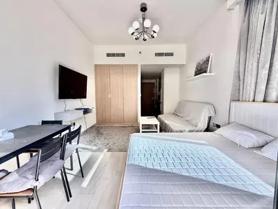 a bedroom with a bed and a table and a desk at Luxury studio appartment in Sabkhah