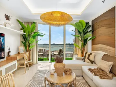a living room with a couch and a table at Chic 1 Bedroom with Palm Views in Palace Beach Residence in Dubai